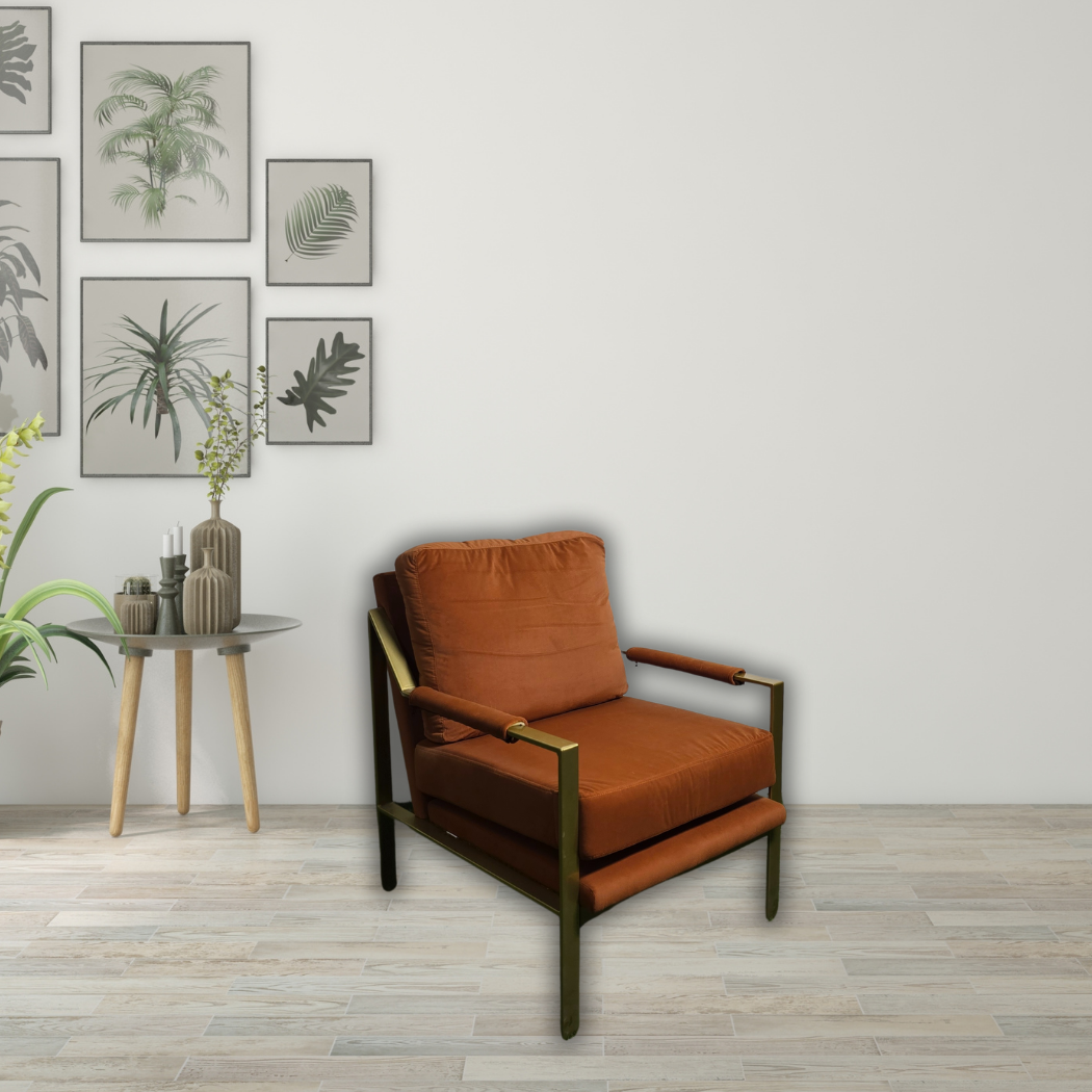 Burnt orange sofa chair with gold armrest and legs