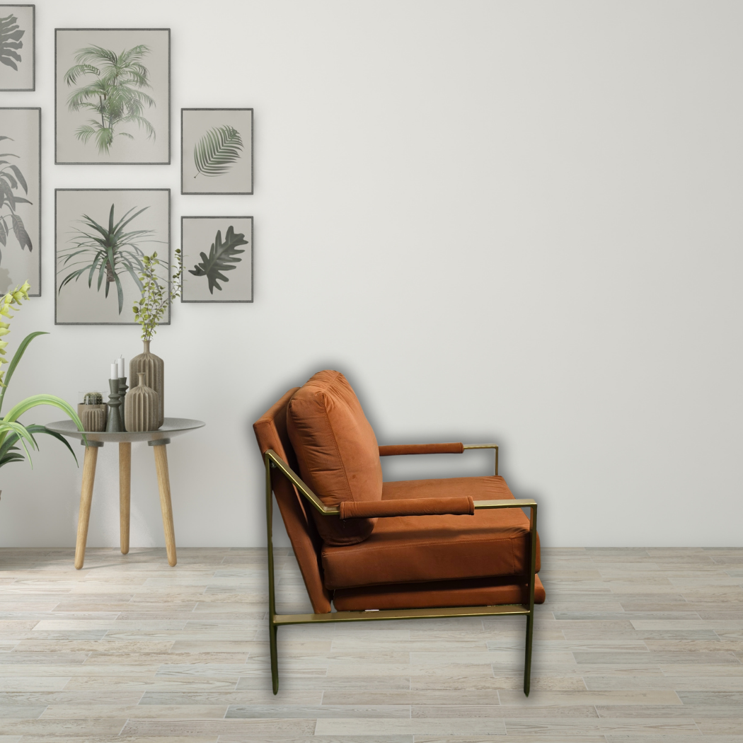 Burnt orange sofa chair with gold armrest and legs