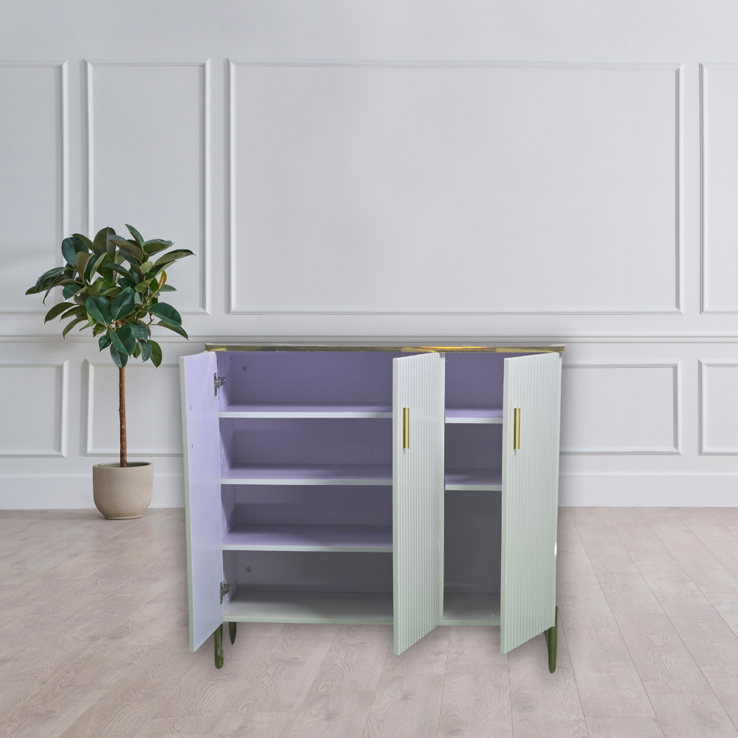 White marble top with black and gold lines, gold outline on top and door handles